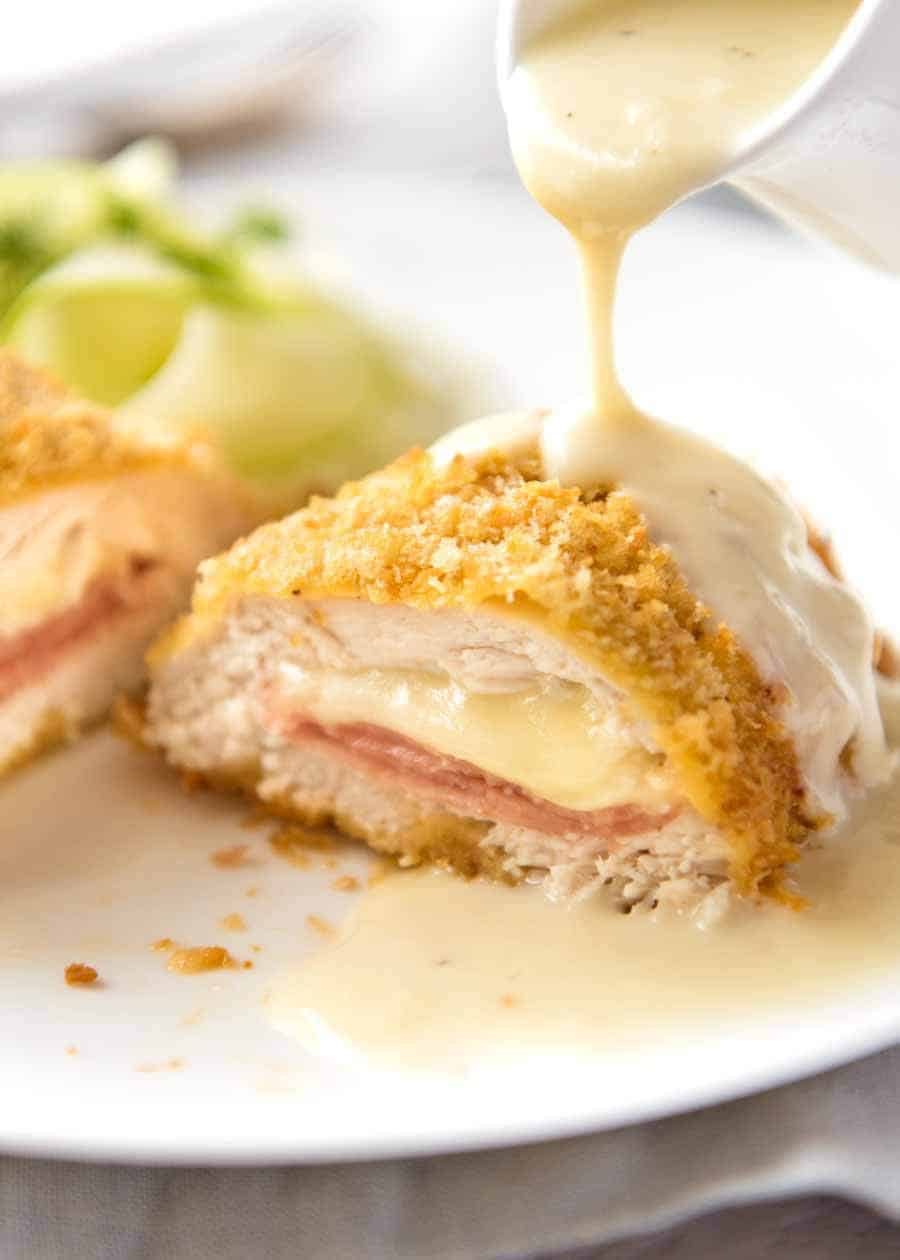 Close up of Dijon Cream Sauce being poured over Easy Chicken Cordon Bleu