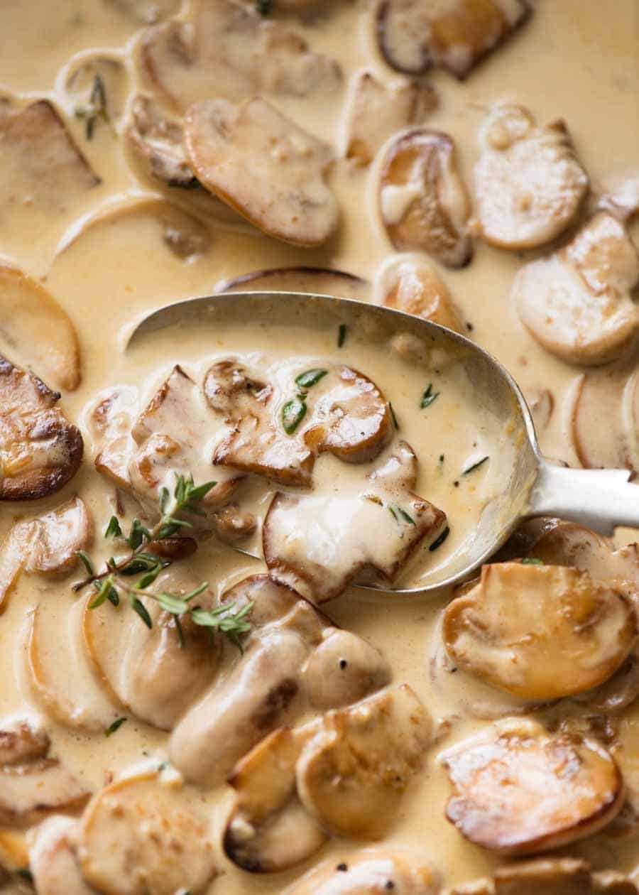 Close up of spoon scooping up Creamy Mushroom Sauce