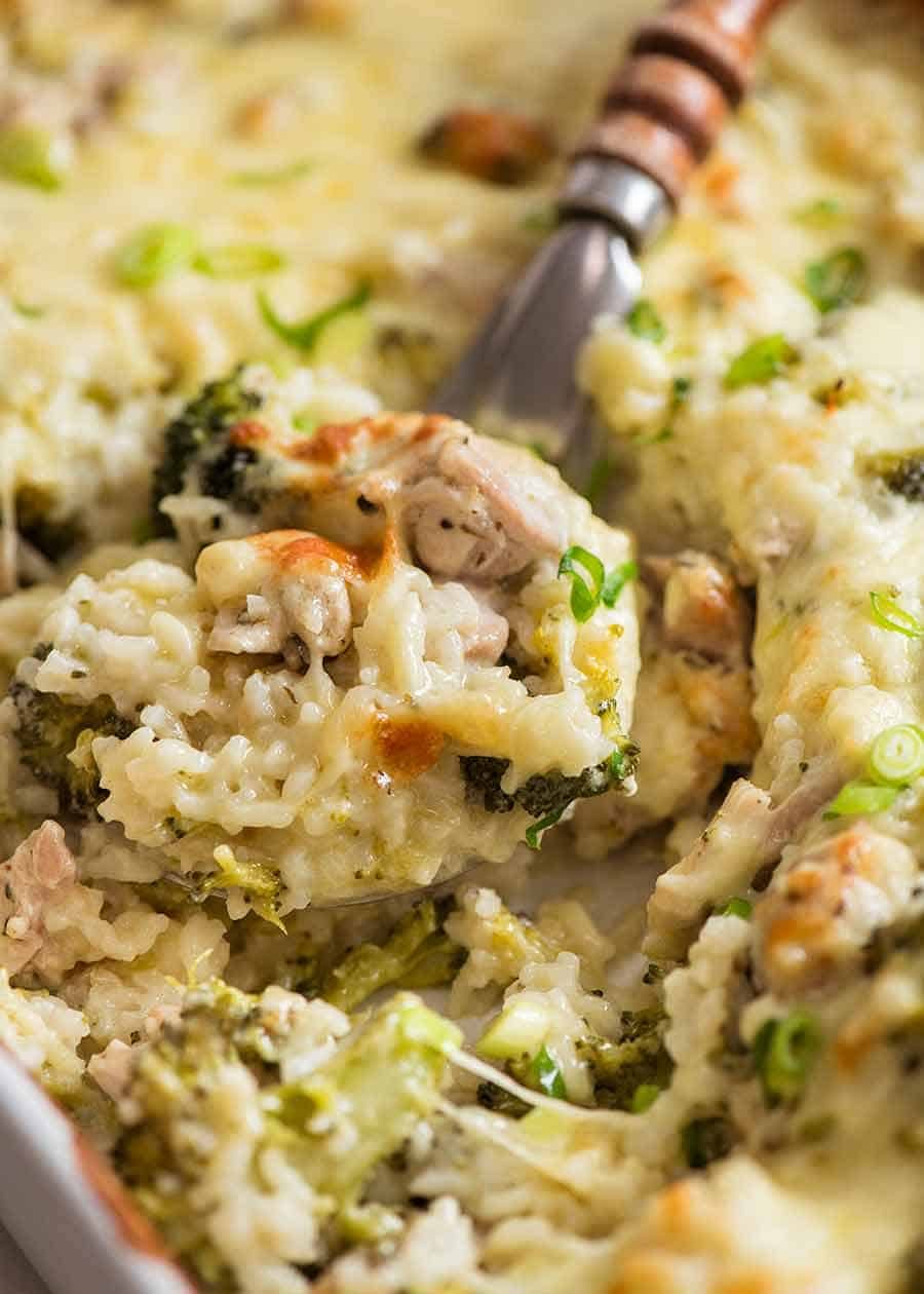 Close up of creamy Emergency Chicken Rice Casserole in a white baking dish, fresh out of the oven