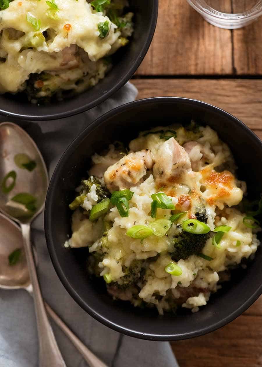 Overhead photo of creamy Chicken Broccoli Rice Casserole in black bowl, ready to be eaten