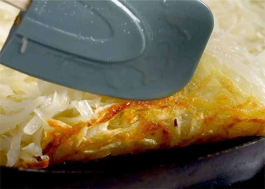 Checking underside of Potato Rosti to see if it's cooked