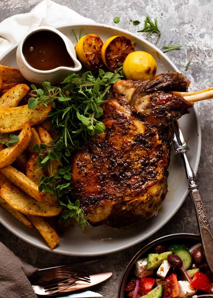 12 Hour Slow Roasted Lamb Shoulder on a platter with lemon roasted ptoatoes